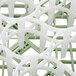 A close-up of a light green Vollrath glass rack with white accents.