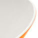 A close up of a sunset orange melamine bowl with a white rim.