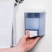 A hand pressing a Noble Chemical Pearl hand soap dispenser.