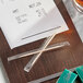 A receipt on a table with Royal Paper toothpicks.