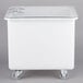 A white plastic Cambro vegetable crisper container with wheels.