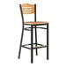 A Lancaster Table & Seating black and natural wood side bar stool with a wooden seat.