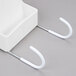 A white plastic Rubbermaid holder with two hooks.