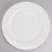 A Tuxton AlumaTux Pearl White china plate with a circular edge on a white background.