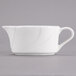 A Tuxton San Marino AlumaTux Pearl White china gravy boat with a handle.