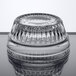 A clear Libbey Winchester glass ramekin on a reflective surface.