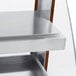 A close up of a Hatco metal shelf on a Hatco countertop.