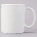 A Tuxton AlumaTux Pearl White china mug with a white handle.