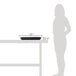 A woman standing next to a table with a black melamine full size food pan on it.