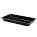 A black rectangular GET melamine food pan on a counter.