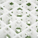 A close up of a white and green plastic grid for a Vollrath Signature glass rack.