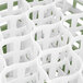 A close-up of a white and green Vollrath glass rack.
