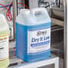 Two cases of Noble Chemical Dry It Low Rinse Aid on a metal shelf.