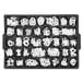 A tray of white Aarco Helvetica letters and numbers.