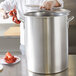 A person using a Vollrath Wear-Ever 80 Qt. Boiler / Fryer Set to cook a lobster.