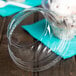 A close-up of a Fabri-Kal clear plastic dome lid on a clear plastic container of ice cream.