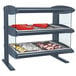A Hatco heated zone merchandiser with shelves of food on a countertop.
