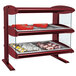 A red Hatco countertop heated zone display case with food on two shelves.