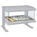 A Hatco white granite countertop heated zone merchandiser with food on a silver tray.