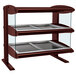 A Hatco horizontal double shelf heated zone merchandiser with glass shelves on a bakery counter.
