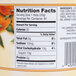 A glass jar of orange marmalade on a counter with a label.