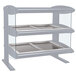 A white Hatco countertop heated zone merchandiser with two shelves holding trays.