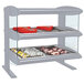 A Hatco heated zone merchandiser with food on two shelves.