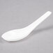 a white spoon on a gray surface