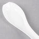 A WNA Comet white plastic Asian soup spoon.