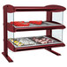 A red Hatco countertop display case with food on two shelves.