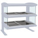 A white Hatco heated zone merchandiser shelf with three trays on it.