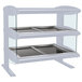 A white Hatco heated food shelf with trays on it.