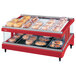 A Hatco red heated glass display case with food on a shelf.