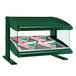A green Hatco countertop heated food display case with pizza boxes inside.