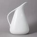 A white pitcher with a handle.