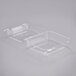 Two Dart clear hinged PET plastic containers with lids.