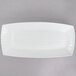 A white rectangular porcelain platter with wavy lines.