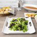 A white rectangular porcelain platter with salad and shrimp on it.