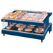 A Hatco navy blue heated glass shelf holding food on a bakery display shelf.