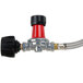 A close-up of a Backyard Pro gas regulator with a red and black hose.
