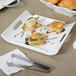 A white rectangular porcelain platter with food on it.