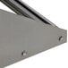 A white metal wall-mounted tubular rack shelf bracket with bolts.