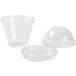 A group of Squat clear plastic cups with Fabri-Kal lids.