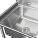 An Advance Tabco stainless steel 3 compartment corner sink with two drainboards.