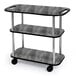 A Geneva rectangular 3 shelf laminate tableside service cart with handle cutouts and pewter brush finish on wheels.