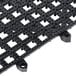 A black San Jamar Versa-Mat interlocking grid with holes.