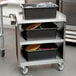 A Lakeside stainless steel utility cart with three shelves.
