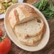 A piece of bread on a Carlisle tan oval platter.
