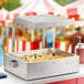 A Hatco fry holding station with french fries inside on a counter in an outdoor catering setup.