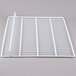 A white wire mesh shelf for an Avantco undercounter refrigerator.